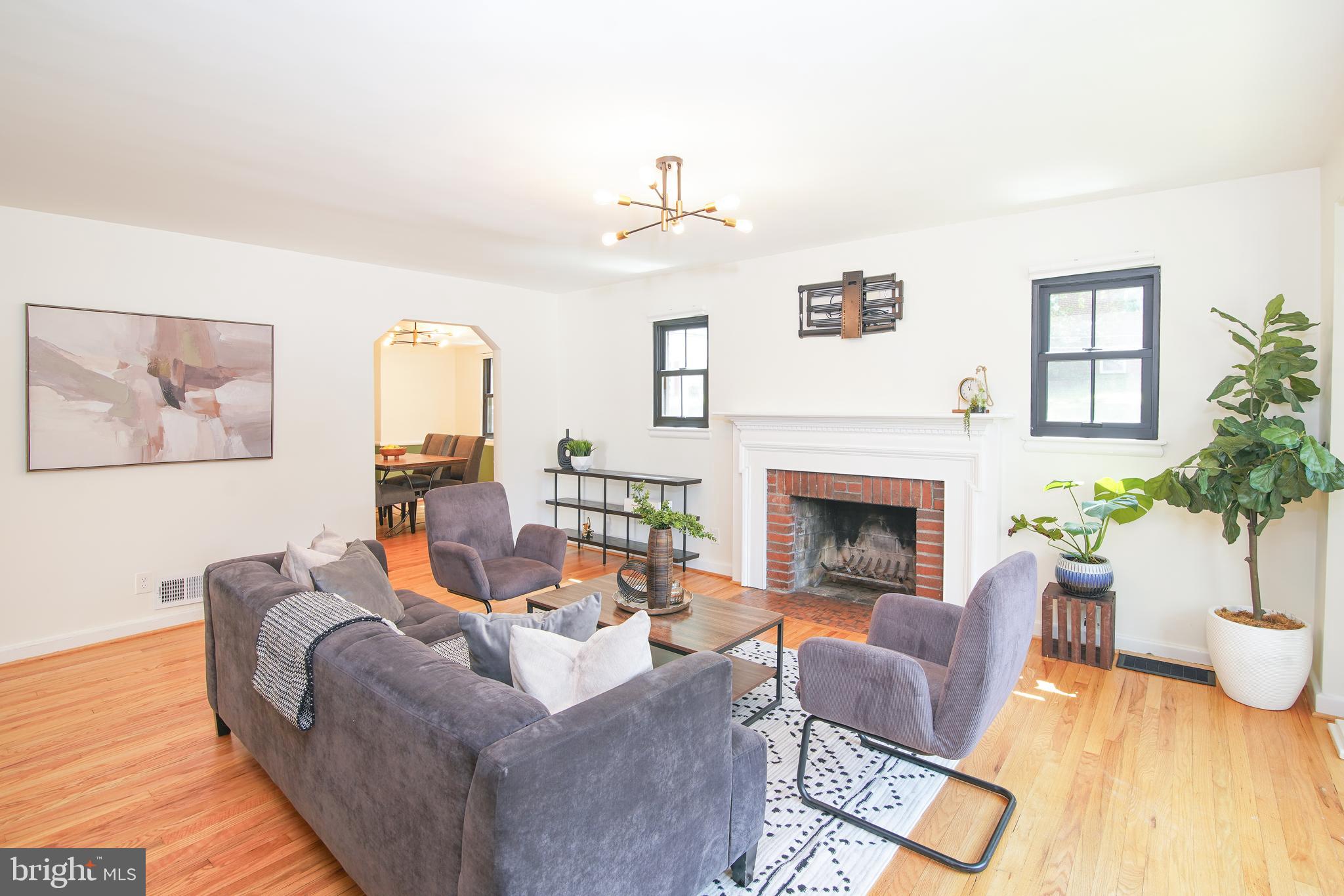 5602 Hawthorne Street Capitol Heights, MD 20743 - Photo 7 of 68 a living room with furniture a fireplace and potted plants