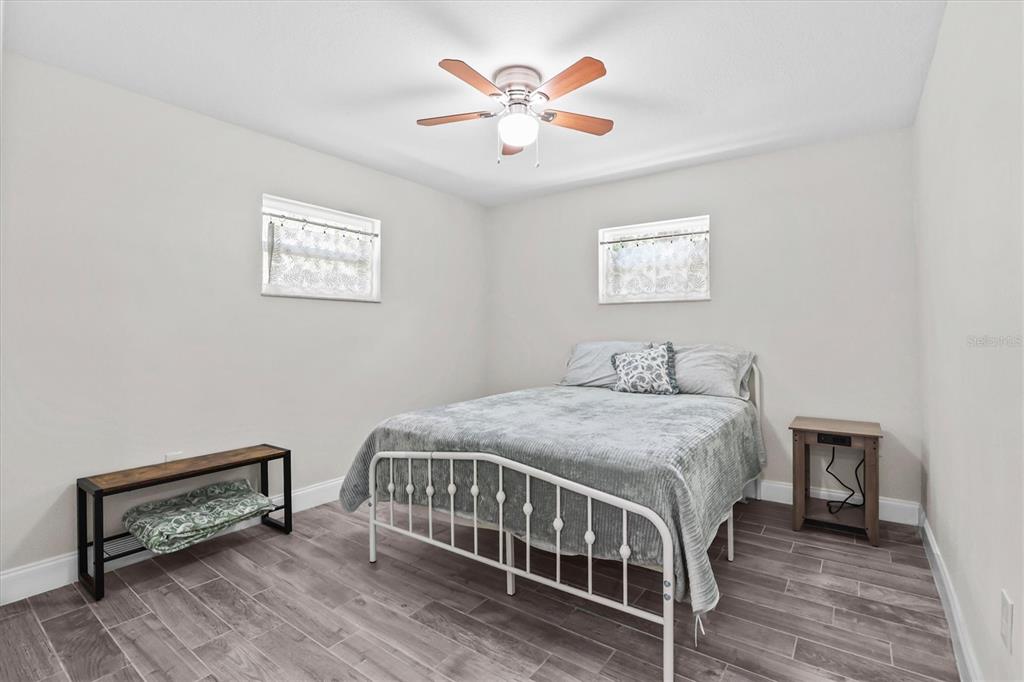6244 Colony Circle Weeki Wachee, FL 34607 - Photo 50 of 60 a bedroom with a bed table and a window