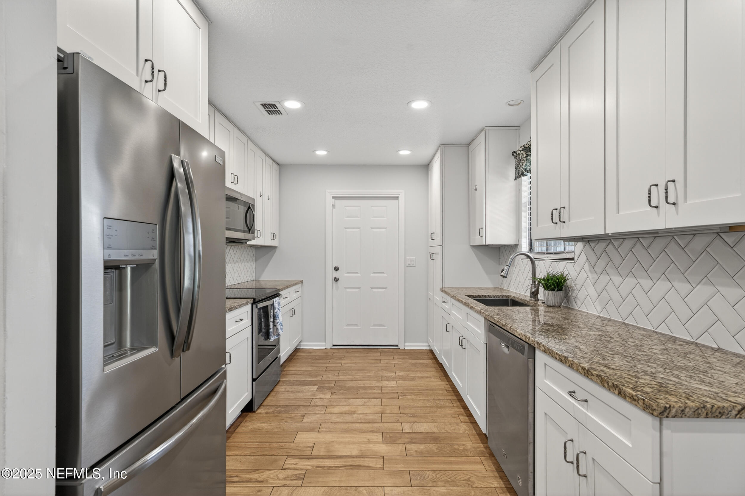 2836 Eagle Point Road Middleburg, FL 32068 - Photo 11 of 44 a kitchen with a sink stove and refrigerator