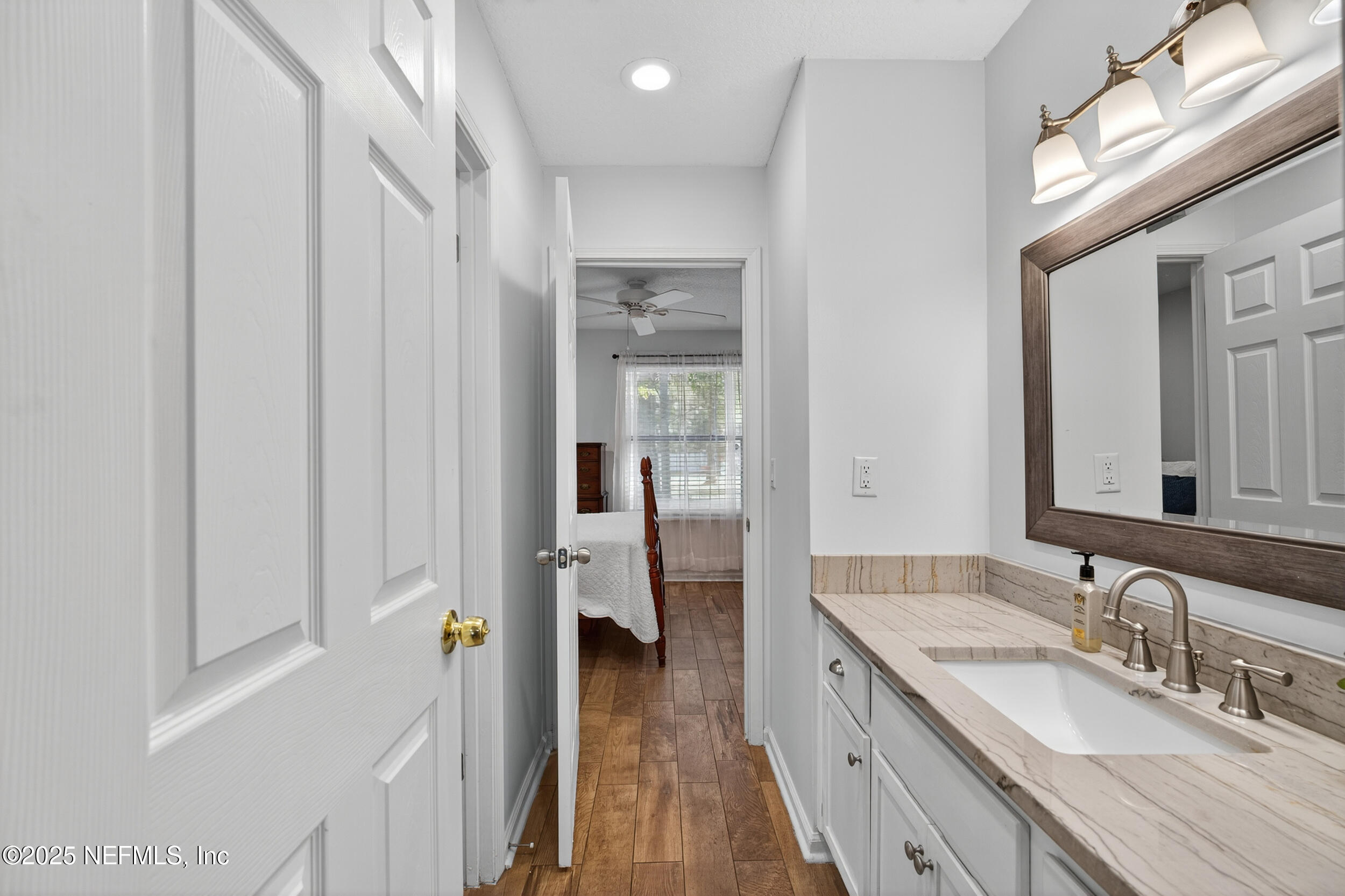 2836 Eagle Point Road Middleburg, FL 32068 - Photo 18 of 44 a spacious bathroom with a granite countertop sink and a mirror