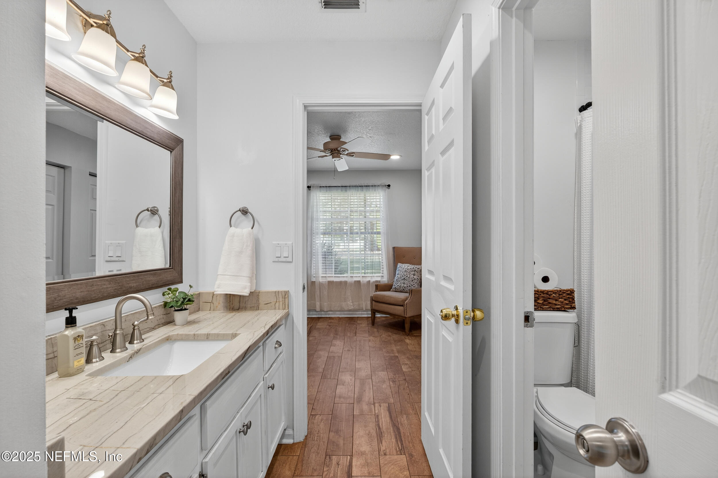 2836 Eagle Point Road Middleburg, FL 32068 - Photo 21 of 44 a en suite bathroom with a granite countertop sink a mirror and a shower