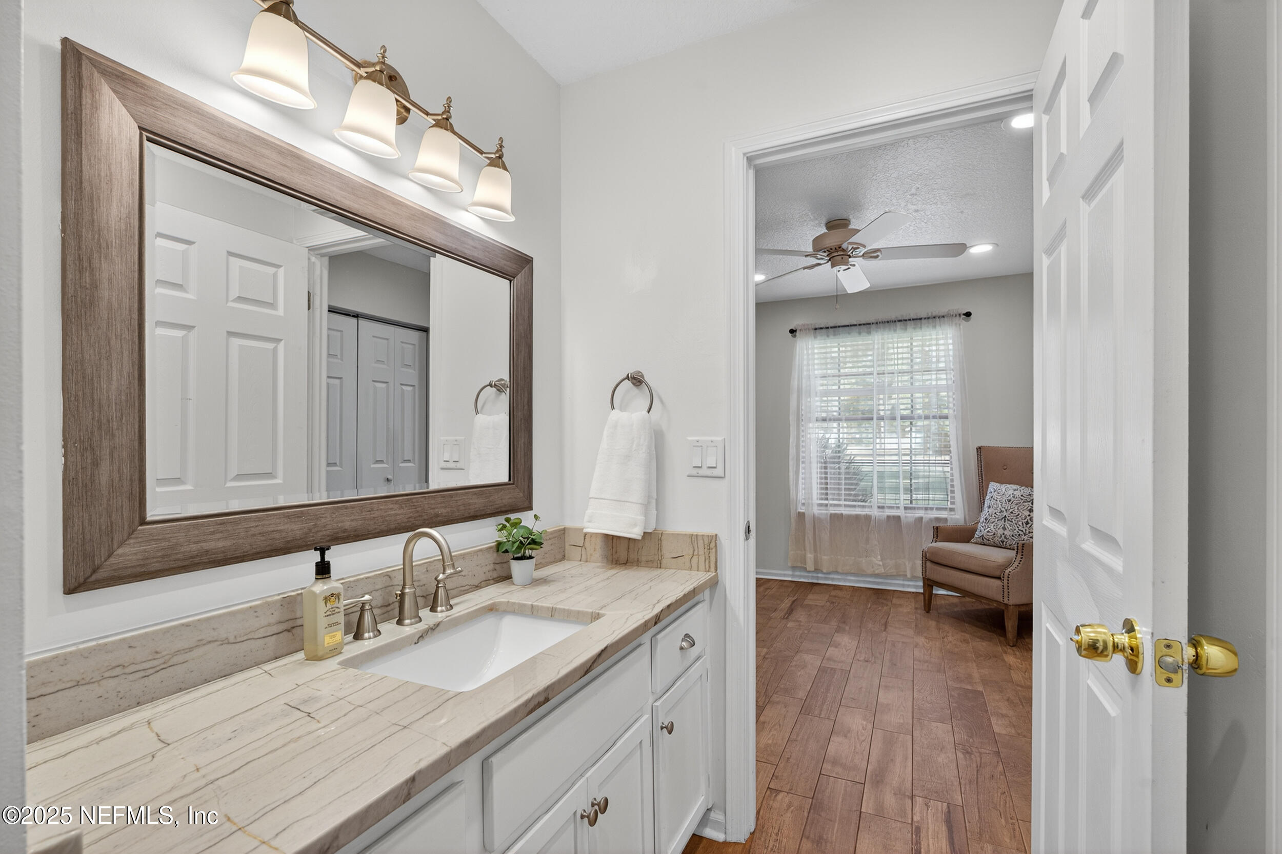 2836 Eagle Point Road Middleburg, FL 32068 - Photo 22 of 44 a en suite bathroom with a granite countertop sink a toilet and a mirror