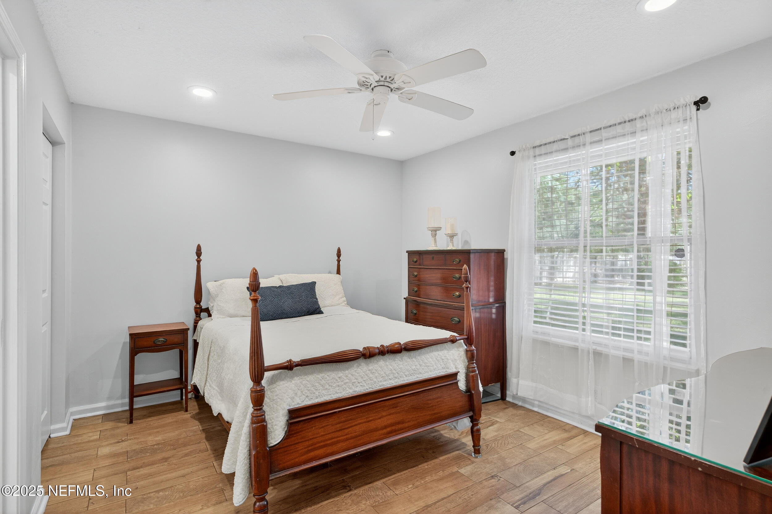 2836 Eagle Point Road Middleburg, FL 32068 - Photo 23 of 44 a bedroom with a bed window and a table