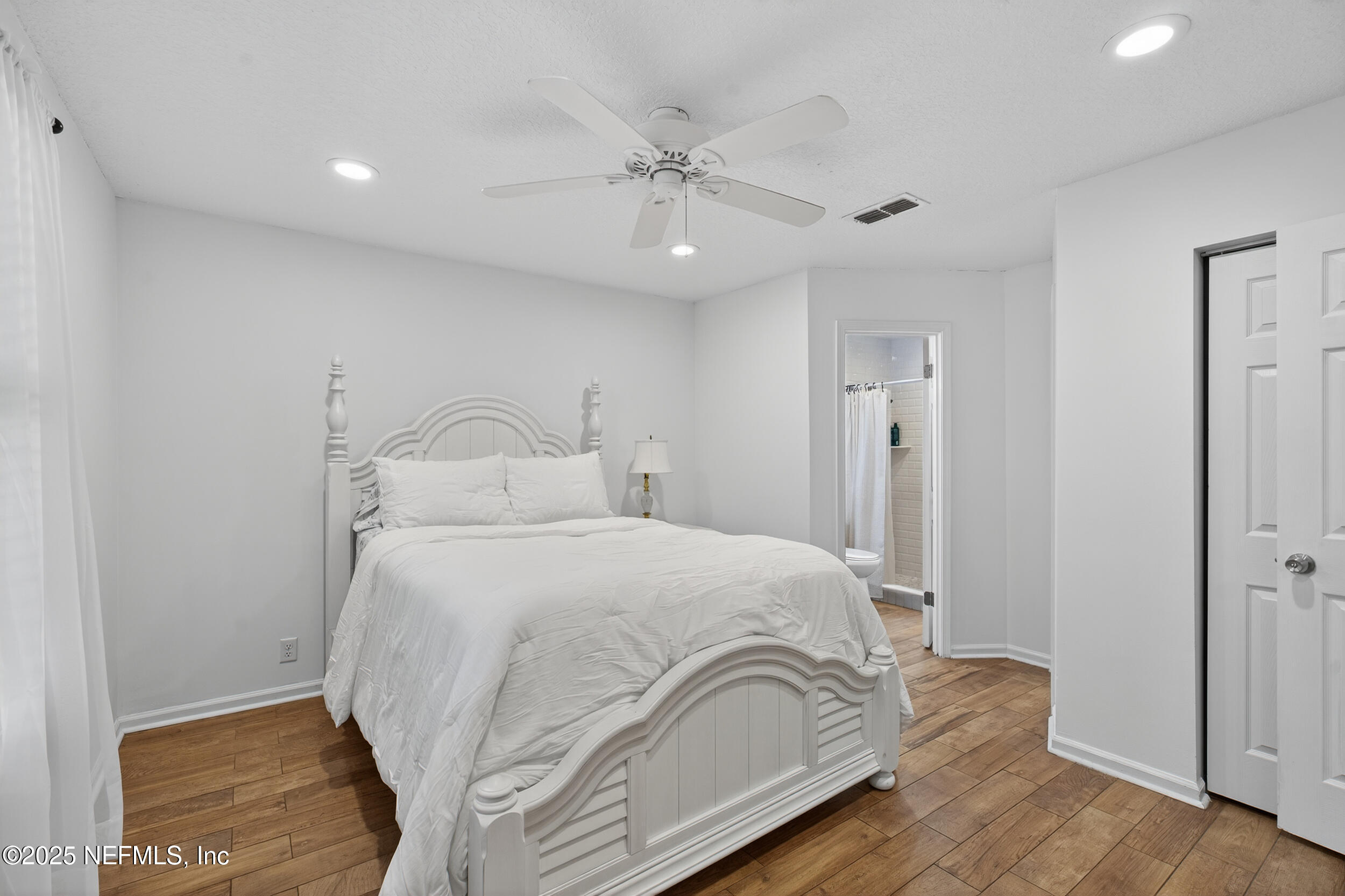2836 Eagle Point Road Middleburg, FL 32068 - Photo 26 of 44 a bedroom with a bed and a ceiling fan