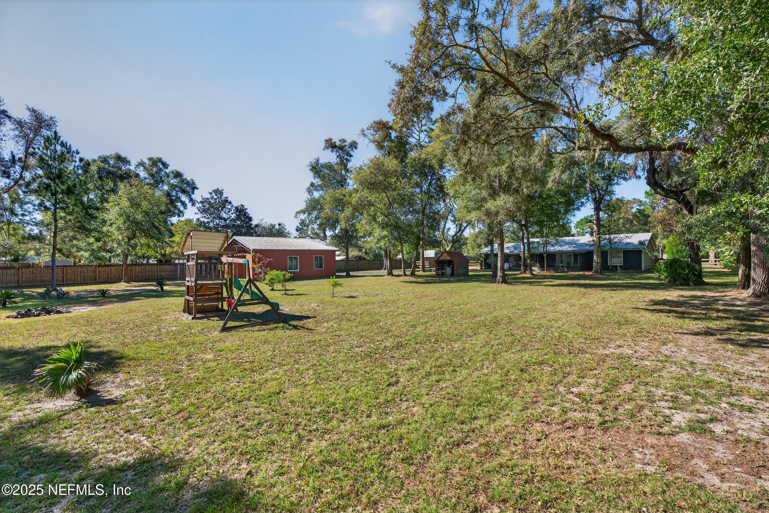 2836 Eagle Point Road Middleburg, FL 32068 - Photo 34 of 44 a view of a park with swings and a bench