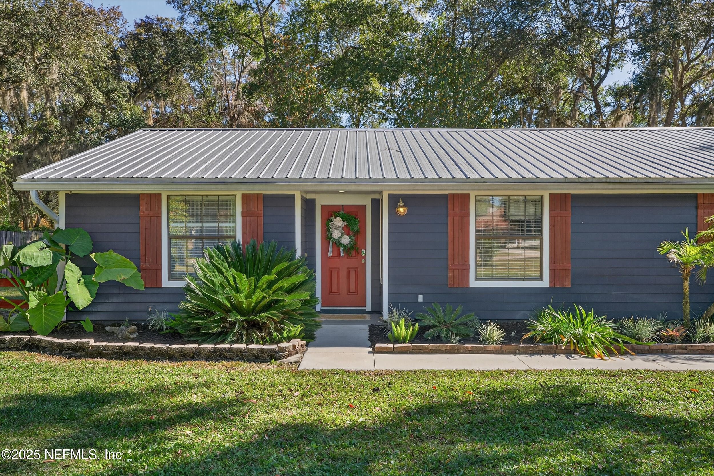 2836 Eagle Point Road Middleburg, FL 32068 - Photo 4 of 44 a front view of house with a garden