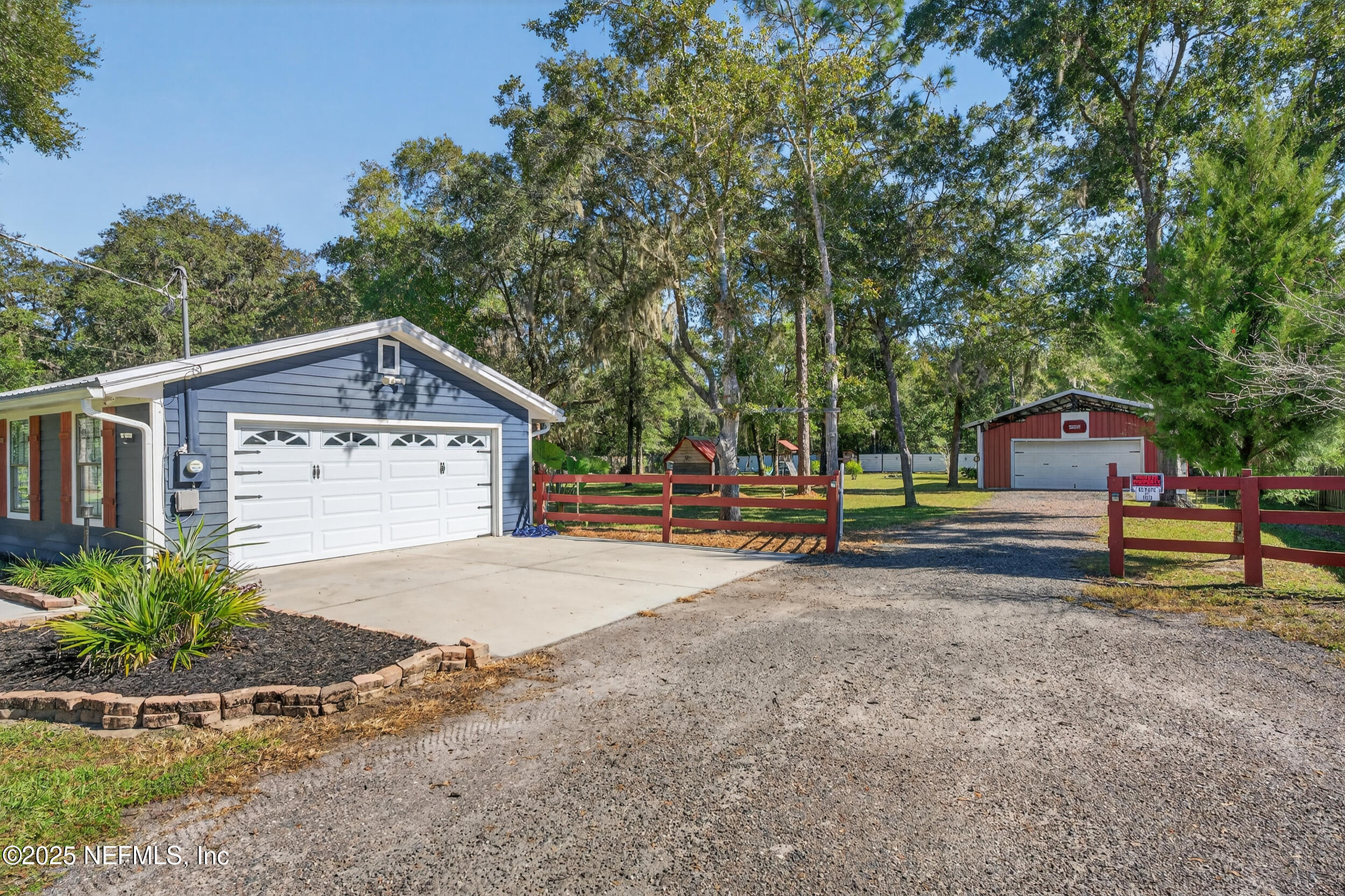 2836 Eagle Point Road Middleburg, FL 32068 - Photo 5 of 44 a front view of a house with a yard and garage