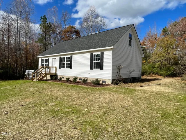 a backyard of a house with seating space