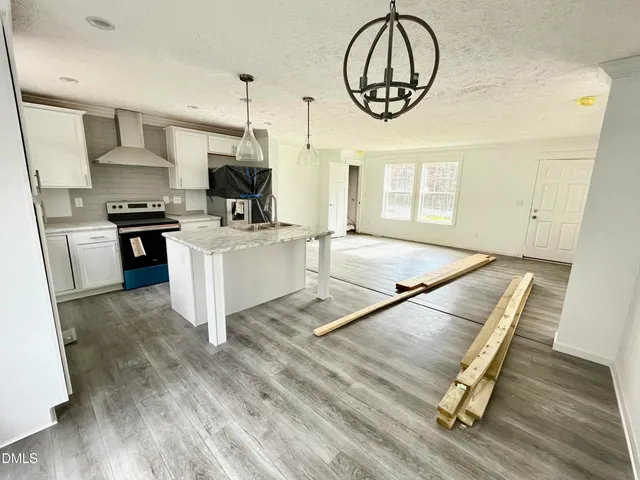 a open kitchen with sink cabinets and a wooden floor