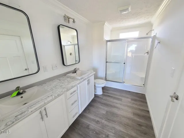 a spacious bathroom with a double vanity sink and a mirror