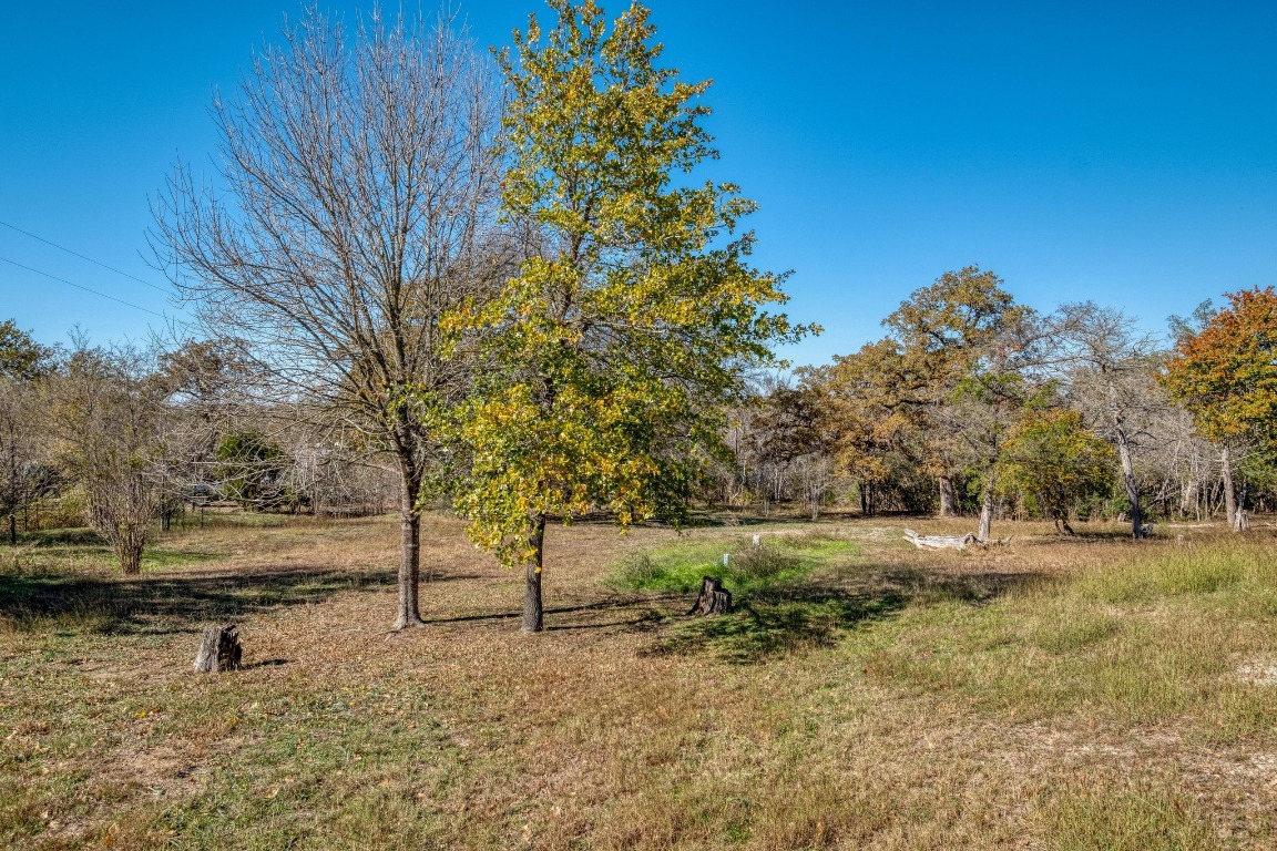 21400 Webberwood Ridge Drive Elgin, TX 78621 - Photo 11 of 22 a view of dirt road with a building in the background