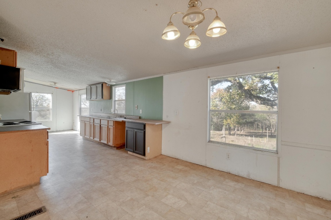 21400 Webberwood Ridge Drive Elgin, TX 78621 - Photo 6 of 22 a open kitchen with furniture and a window