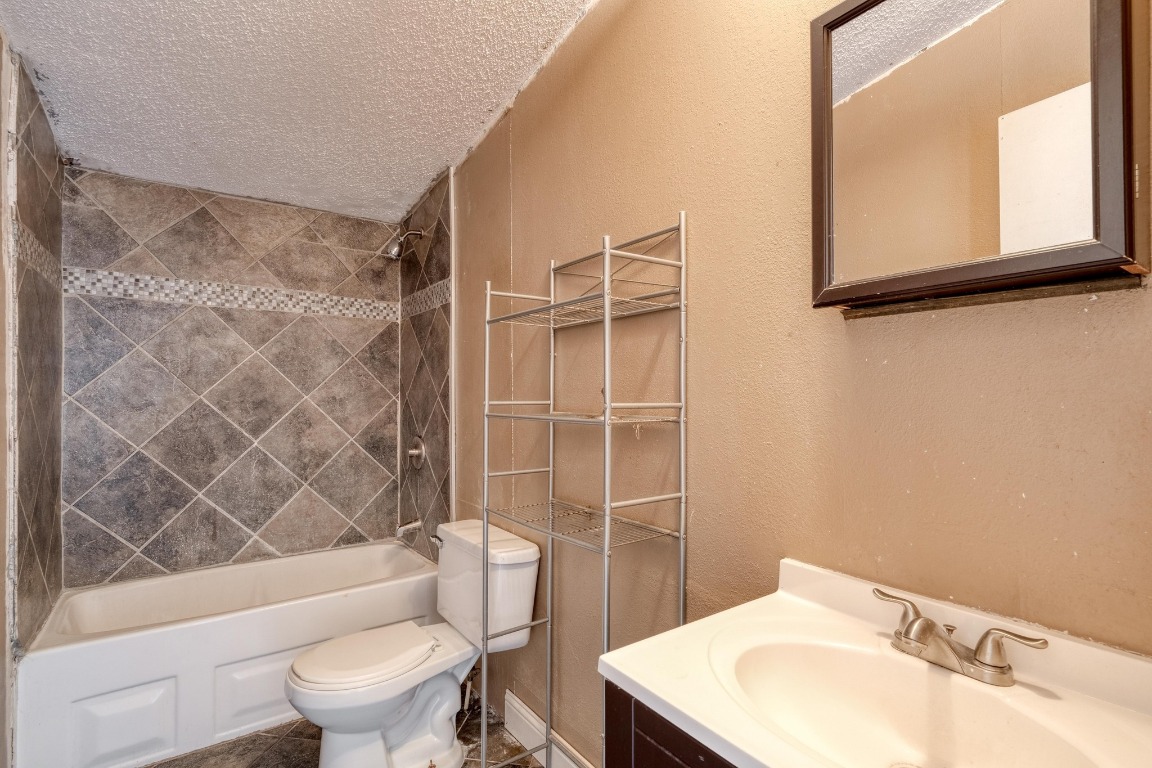 21400 Webberwood Ridge Drive Elgin, TX 78621 - Photo 10 of 22 a bathroom with a sink toilet and shower