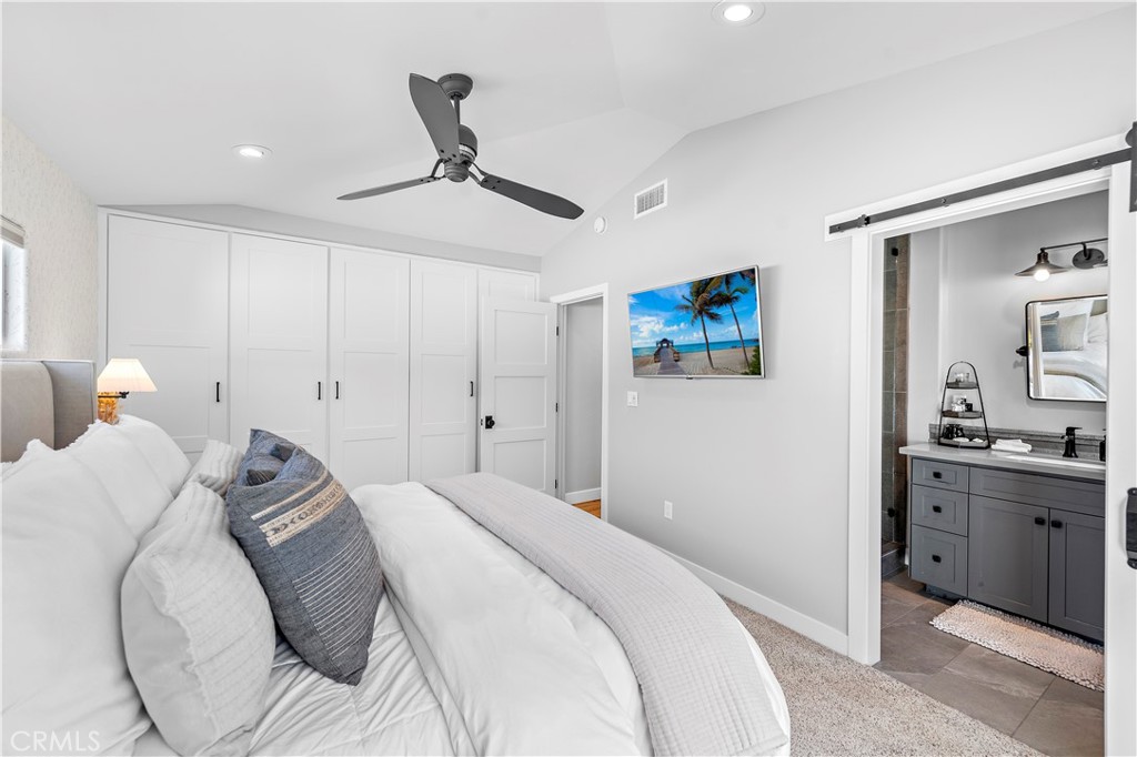 130 West Mariposa San Clemente, CA 92672 - Photo 19 of 43 a bedroom with a bed and a chandelier