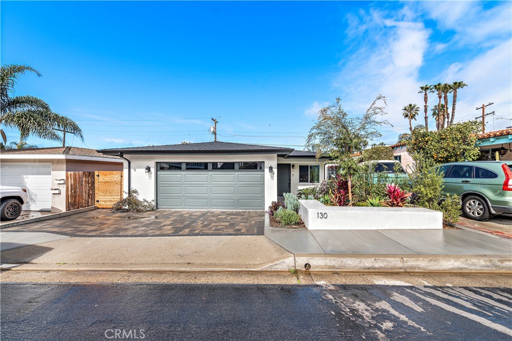 130 West Mariposa San Clemente, CA 92672 - Photo 3 of 43 a front view of a house with a yard and garage