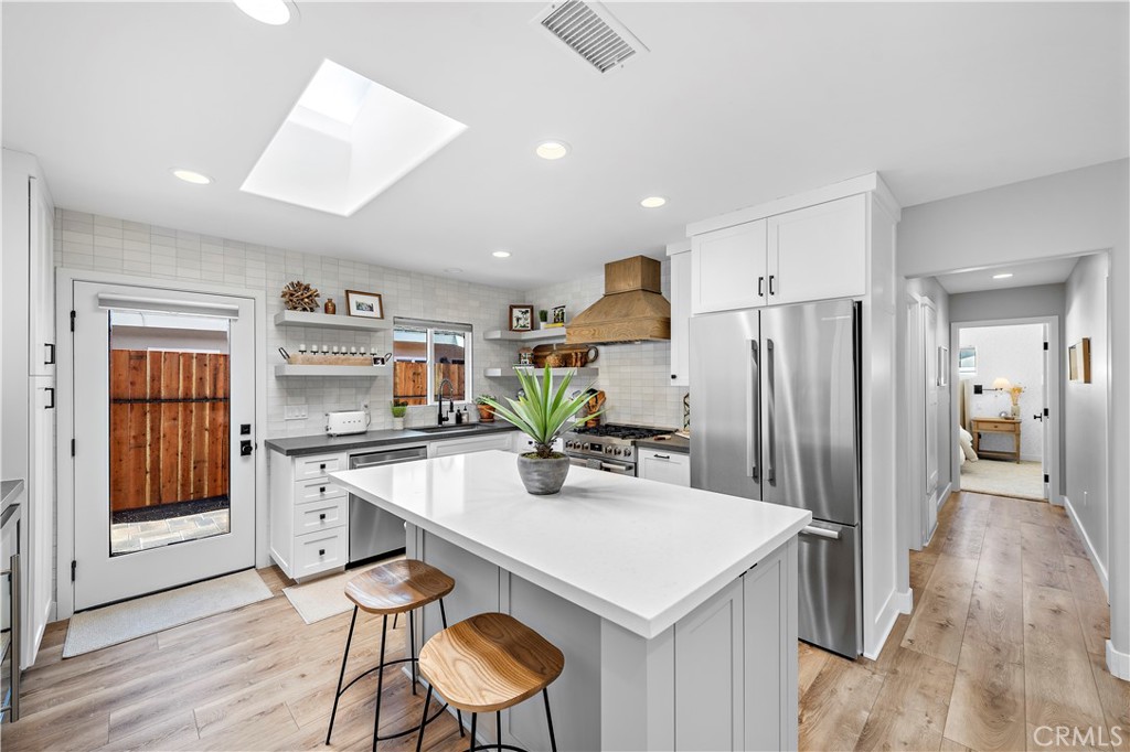 130 West Mariposa San Clemente, CA 92672 - Photo 10 of 43 a kitchen with stainless steel appliances a dining table chairs and refrigerator