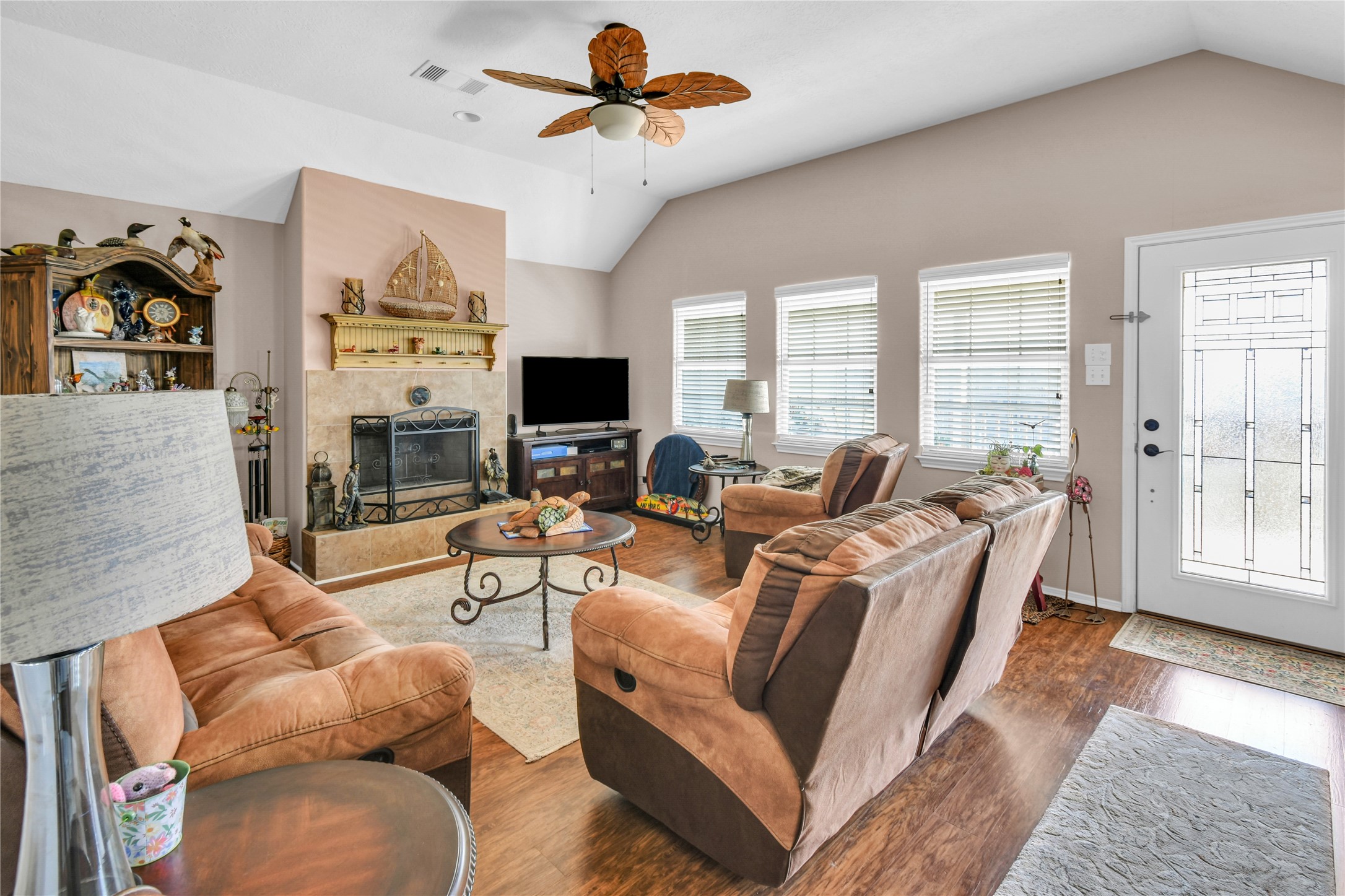 115 Driftwood Road Freeport, TX 77541 - Photo 9 of 21 a living room with furniture a flat screen tv and a fireplace