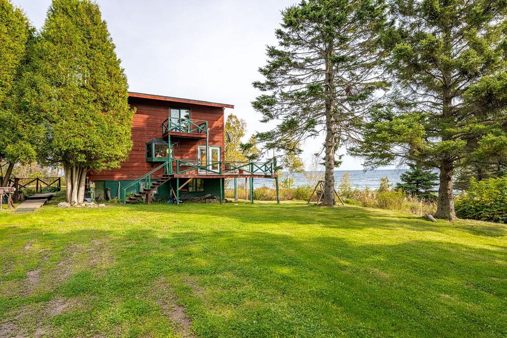 4346 Highway 61 Two Harbors, MN 55616 - Photo 2 of 65 View of grassy yard featuring stairs and a water view