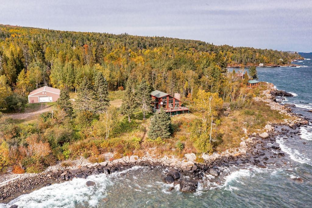 4346 Highway 61 Two Harbors, MN 55616 - Photo 23 of 65 Aerial view of property and surrounding area with a nearby body of water and a forest