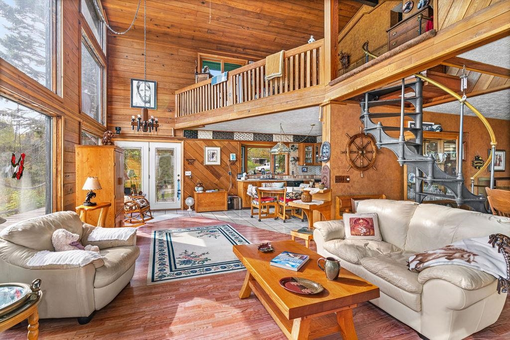 4346 Highway 61 Two Harbors, MN 55616 - Photo 41 of 65 Living room with wood walls, high vaulted ceiling, french doors, and wood finished floors