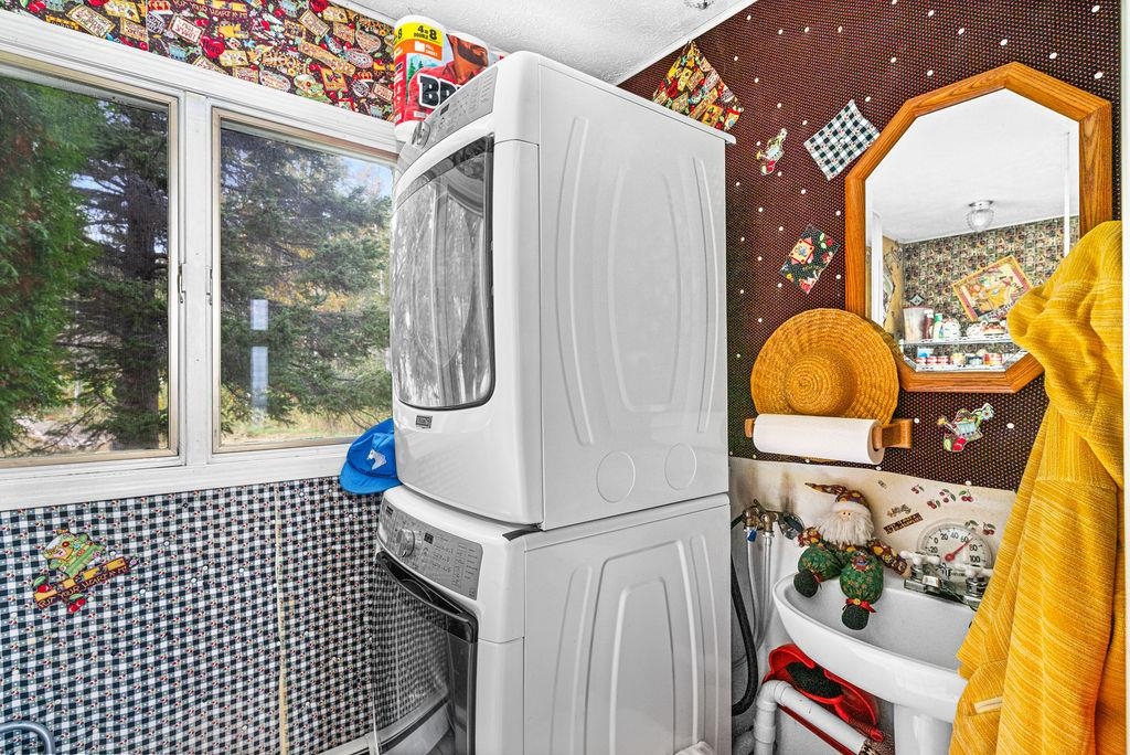 4346 Highway 61 Two Harbors, MN 55616 - Photo 46 of 65 Washroom with wallpapered walls and stacked washer and clothes dryer