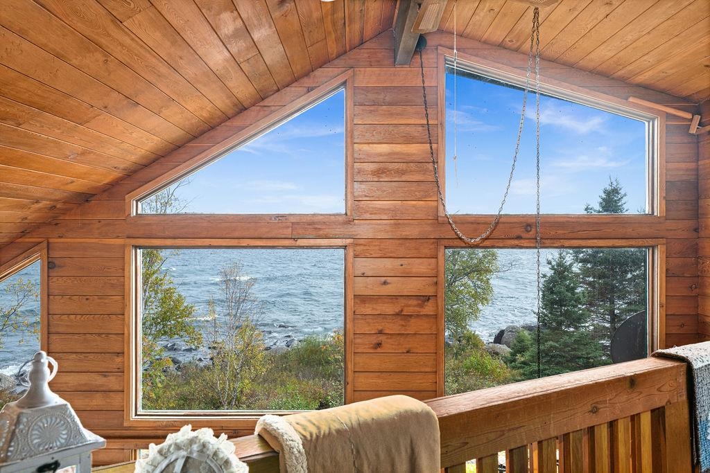 4346 Highway 61 Two Harbors, MN 55616 - Photo 47 of 65 Detailed view of nearby water and a wood ceiling with exposed beams