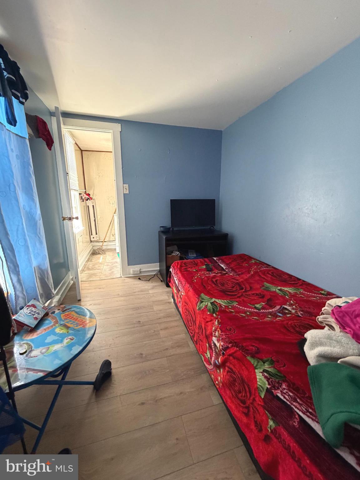 324 Spring Garden Street Reading, PA 19602 - Photo 16 of 20 a bedroom with a bed and wooden floor
