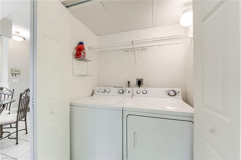 23810 Marbella Bay Road, Unit 202 Estero, FL 34135 - Photo 26 of 33 Full Size Washer and Dryer with storage above