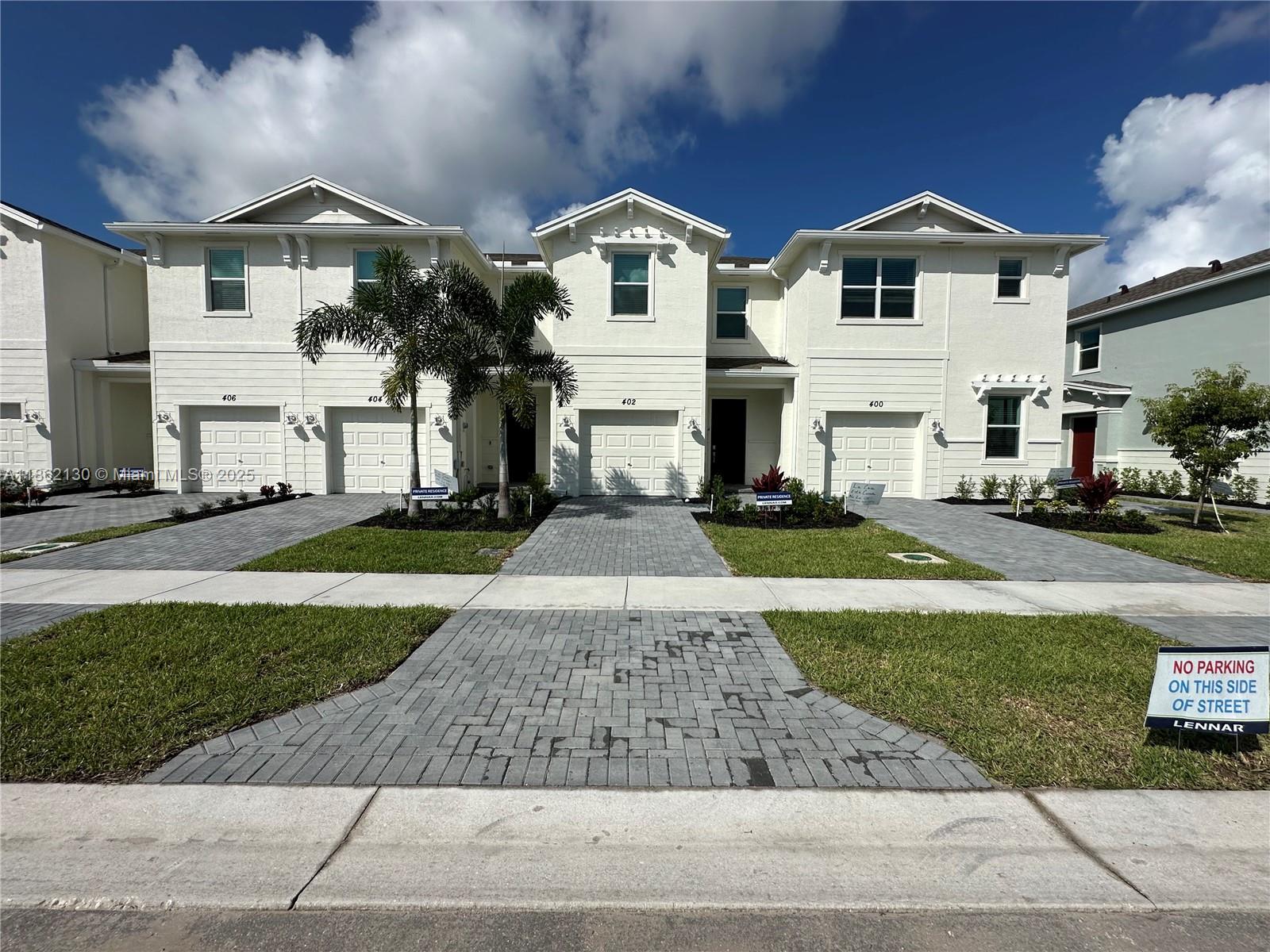 402 Southeast Crossoak Lane, Unit 402 Port St. Lucie, FL 34984 - Photo 17 of 87 a front view of a house with a yard