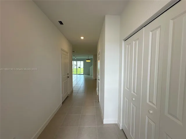 a view of staircase with white walls and a window