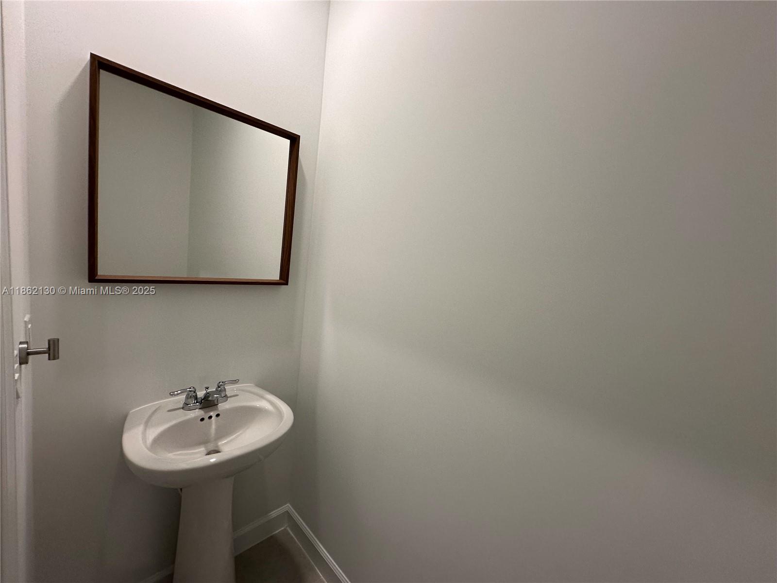 402 Southeast Crossoak Lane, Unit 402 Port St. Lucie, FL 34984 - Photo 24 of 87 a bathroom with a sink and a mirror
