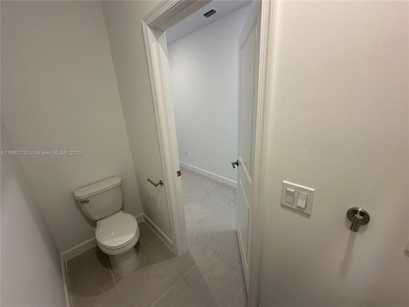 402 Southeast Crossoak Lane, Unit 402 Port St. Lucie, FL 34984 - Photo 25 of 87 a white toilet sitting next to a shower