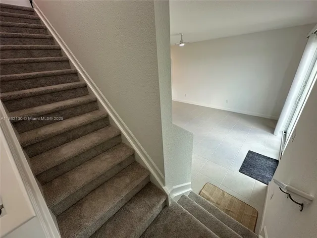 a bathroom with a sink a toilet and shower curtain