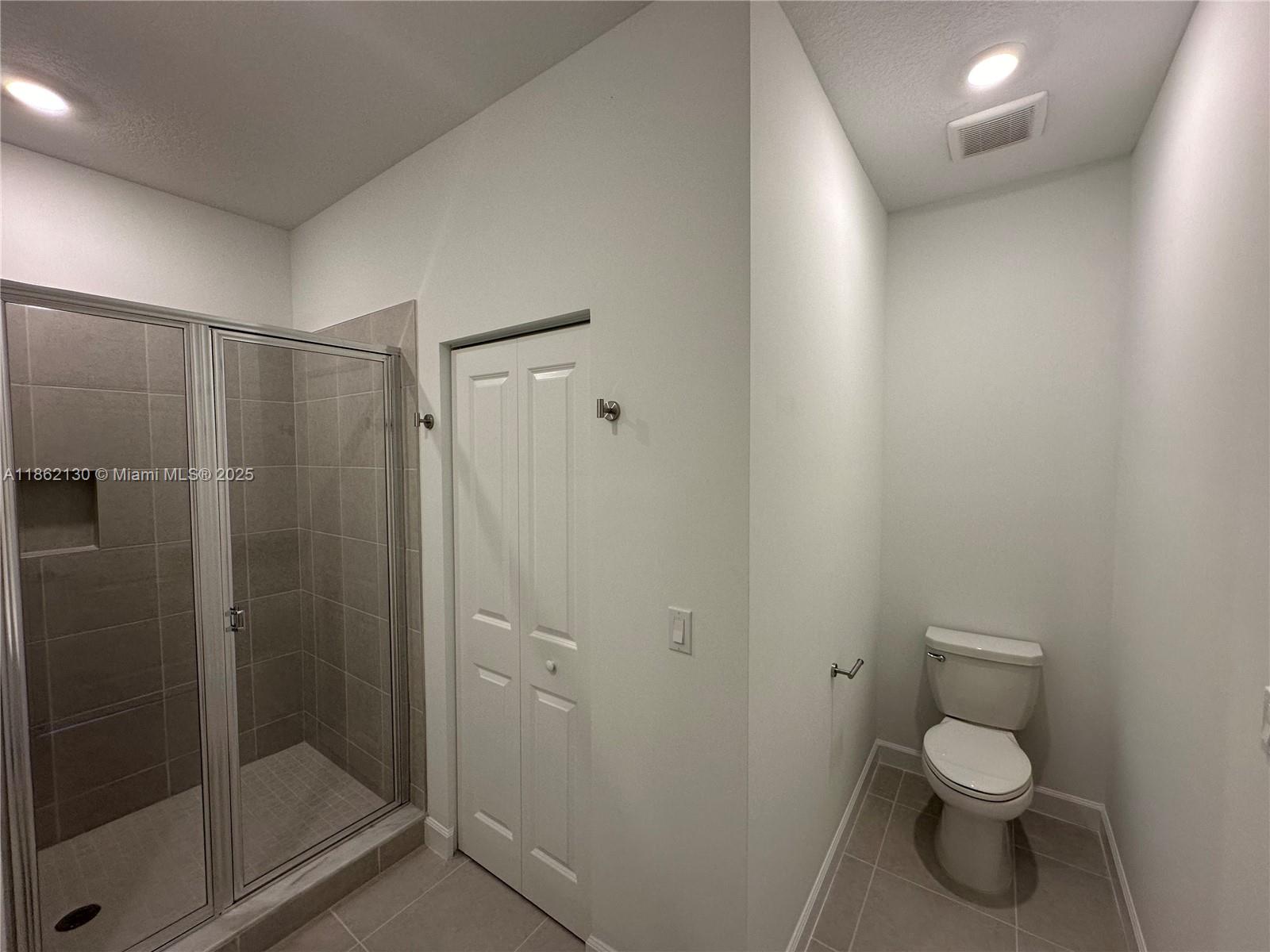 402 Southeast Crossoak Lane, Unit 402 Port St. Lucie, FL 34984 - Photo 39 of 87 a bathroom with a toilet and a shower