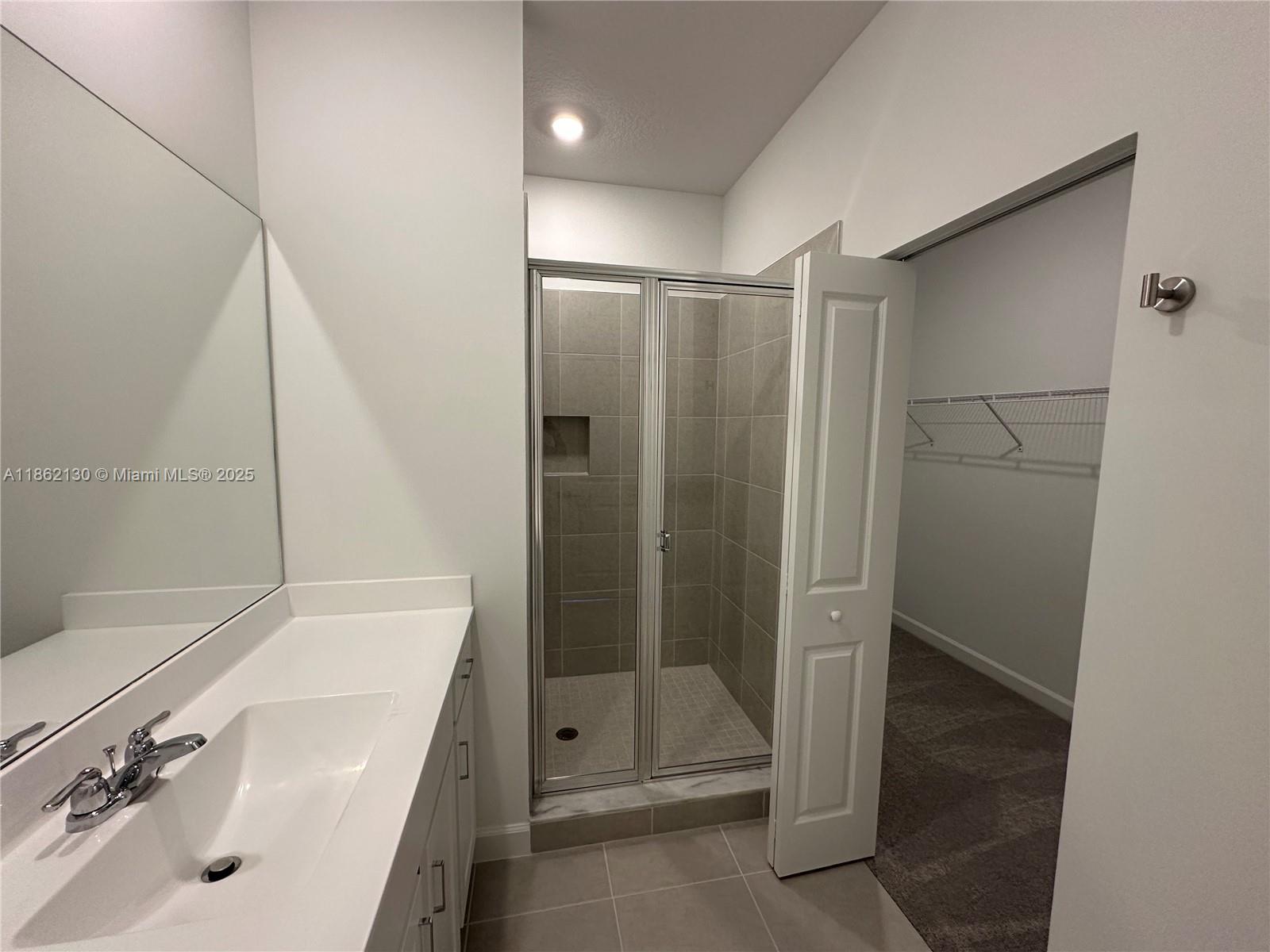 402 Southeast Crossoak Lane, Unit 402 Port St. Lucie, FL 34984 - Photo 40 of 87 a bathroom with a sink and a tub