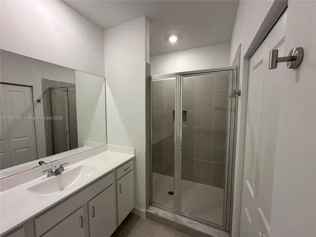 a large kitchen with a large counter top appliances and cabinets