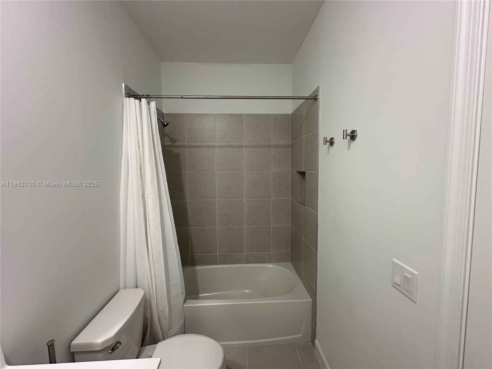 402 Southeast Crossoak Lane, Unit 402 Port St. Lucie, FL 34984 - Photo 55 of 87 a bathroom with a shower and a toilet