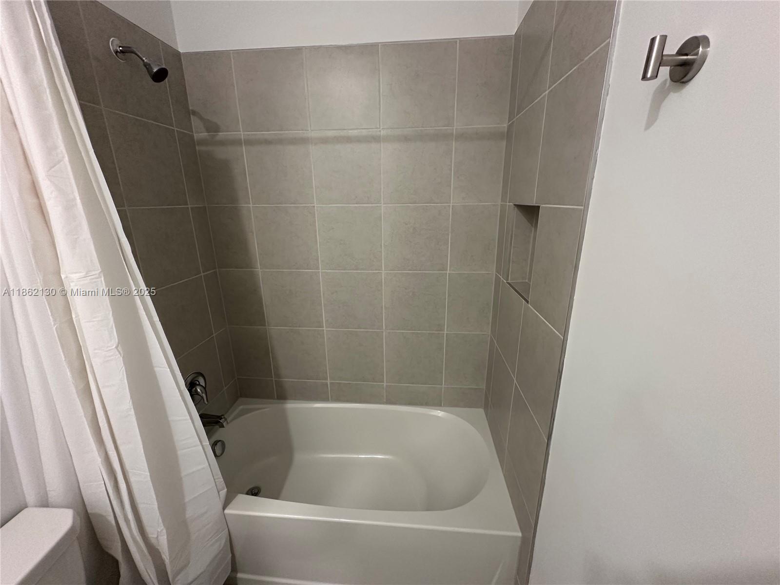 402 Southeast Crossoak Lane, Unit 402 Port St. Lucie, FL 34984 - Photo 56 of 87 a bathroom with a bathtub