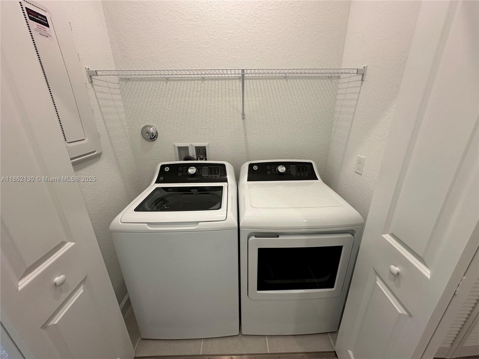 402 Southeast Crossoak Lane, Unit 402 Port St. Lucie, FL 34984 - Photo 6 of 87 a utility room with dryer and washer