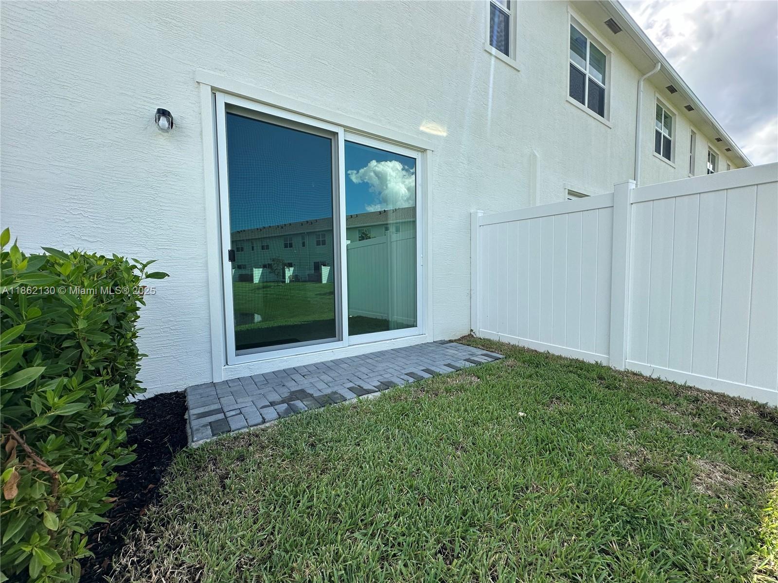 402 Southeast Crossoak Lane, Unit 402 Port St. Lucie, FL 34984 - Photo 61 of 87 a view of a back yard of the house