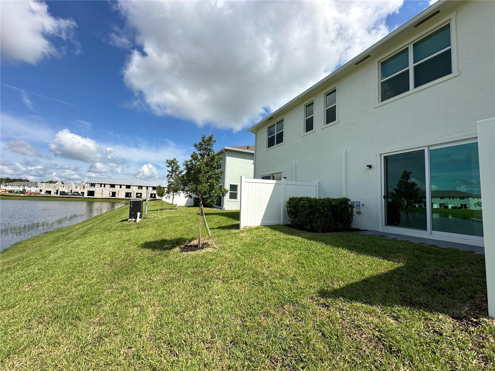402 Southeast Crossoak Lane, Unit 402 Port St. Lucie, FL 34984 - Photo 63 of 87 a view of a house with backyard and sitting area