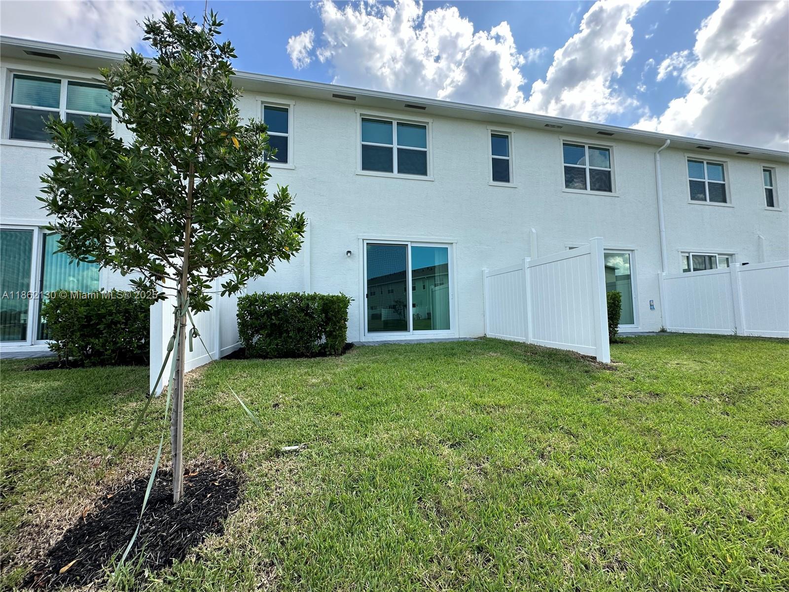 402 Southeast Crossoak Lane, Unit 402 Port St. Lucie, FL 34984 - Photo 65 of 87 a house view with a garden space