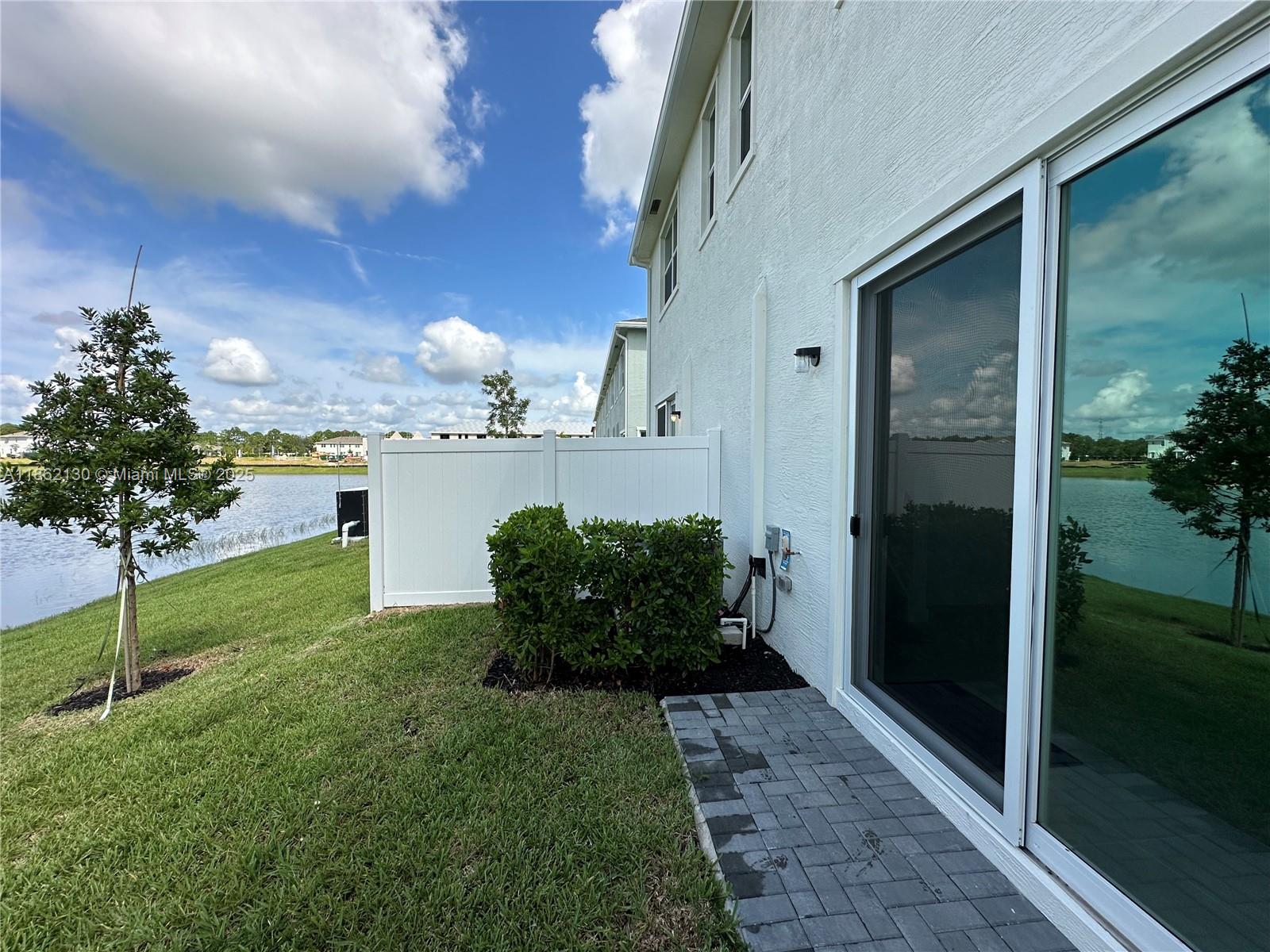 402 Southeast Crossoak Lane, Unit 402 Port St. Lucie, FL 34984 - Photo 67 of 87 a view of a house with a yard