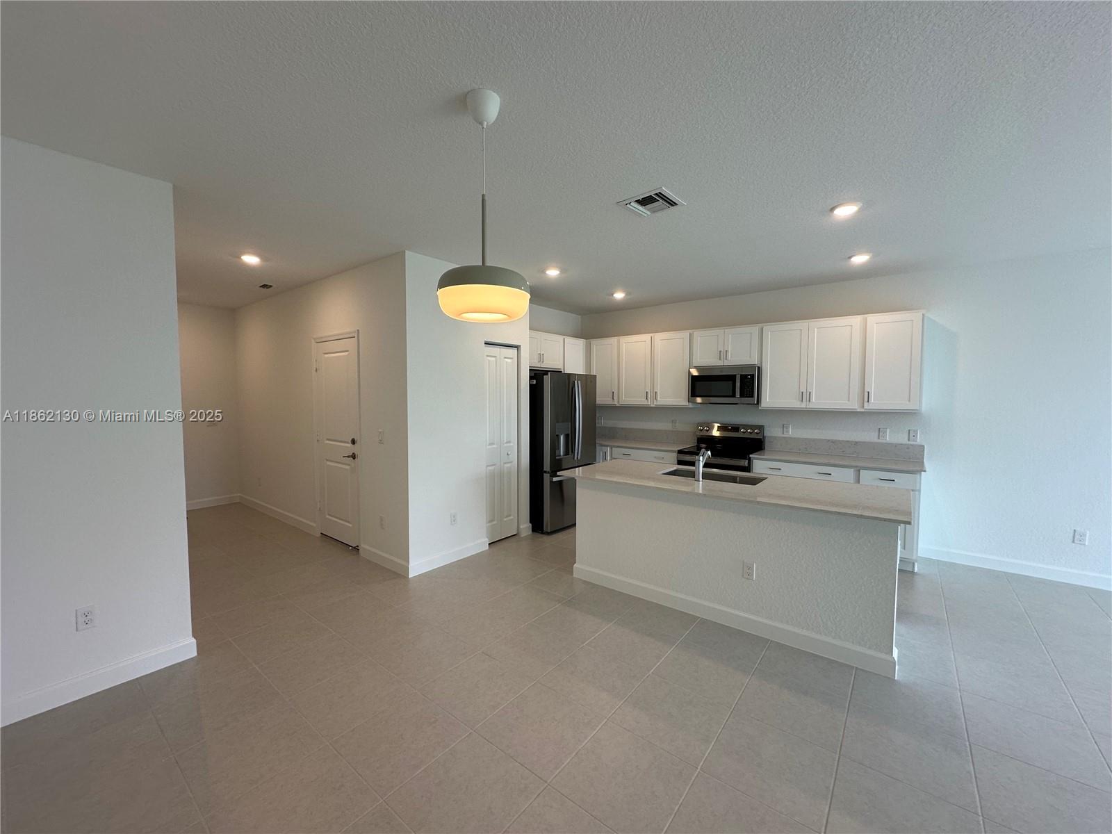 402 Southeast Crossoak Lane, Unit 402 Port St. Lucie, FL 34984 - Photo 73 of 87 a large kitchen with a large counter top appliances and cabinets