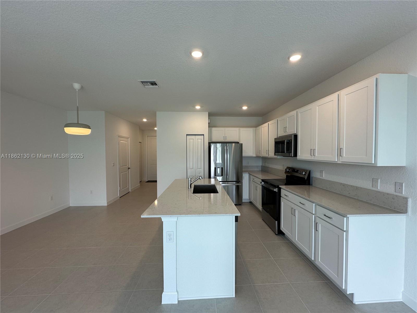 402 Southeast Crossoak Lane, Unit 402 Port St. Lucie, FL 34984 - Photo 76 of 87 a kitchen with cabinets and counter space