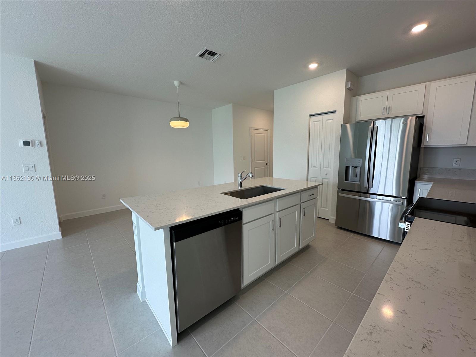 402 Southeast Crossoak Lane, Unit 402 Port St. Lucie, FL 34984 - Photo 79 of 87 a kitchen with stainless steel appliances a refrigerator and a stove