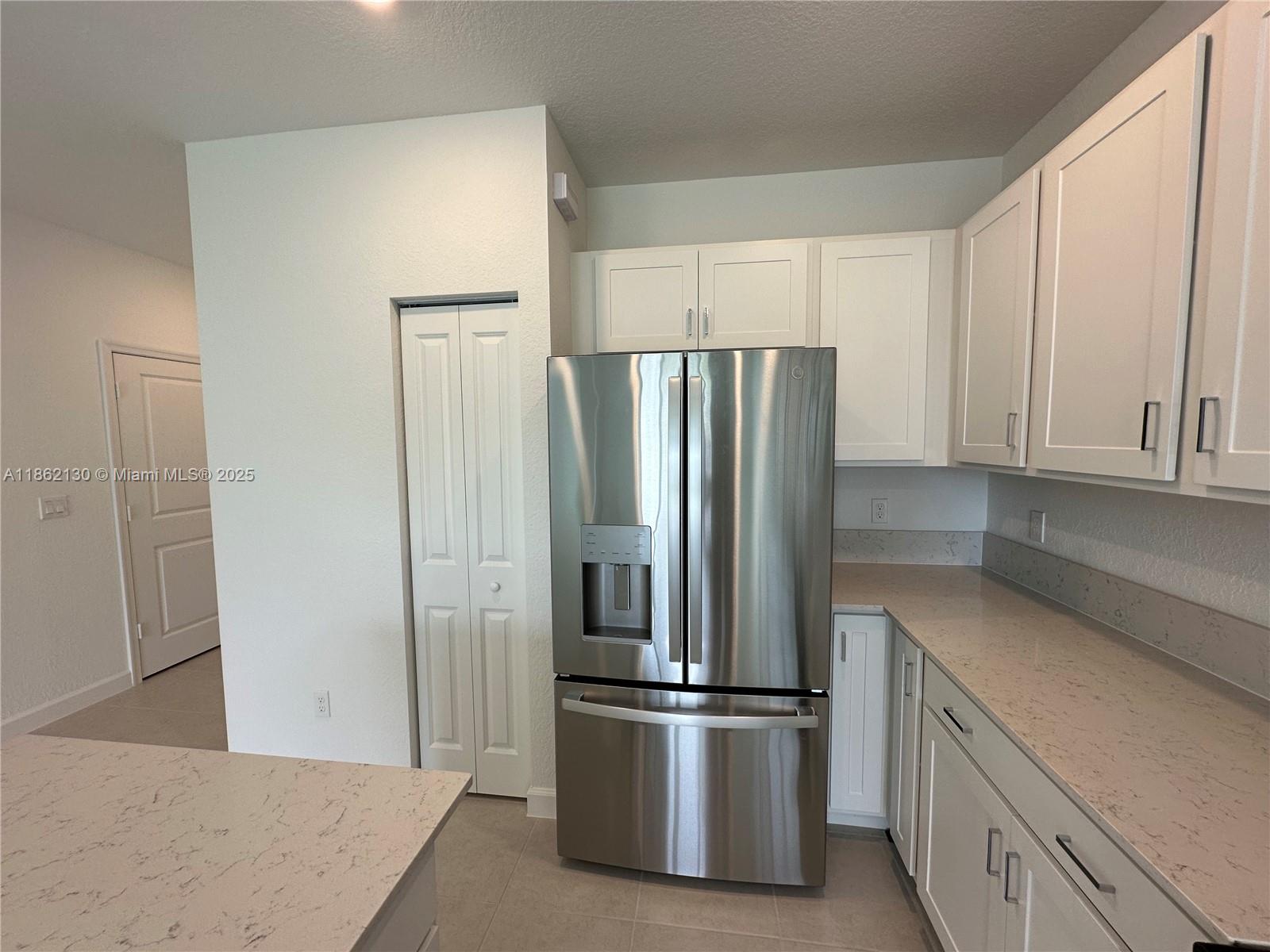 402 Southeast Crossoak Lane, Unit 402 Port St. Lucie, FL 34984 - Photo 80 of 87 a kitchen with stainless steel appliances a refrigerator and a sink