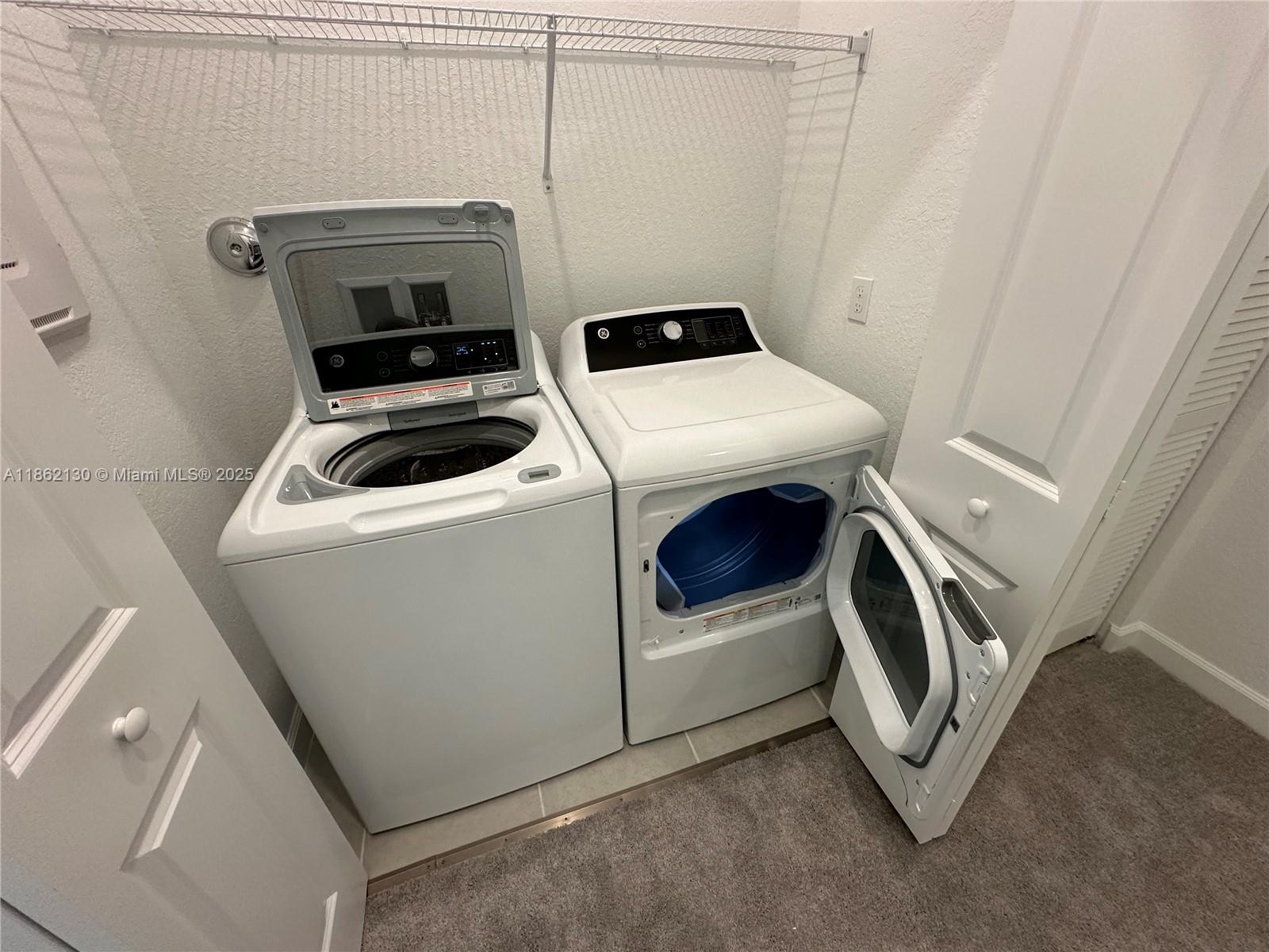 402 Southeast Crossoak Lane, Unit 402 Port St. Lucie, FL 34984 - Photo 85 of 87 a utility room with dryer and washer