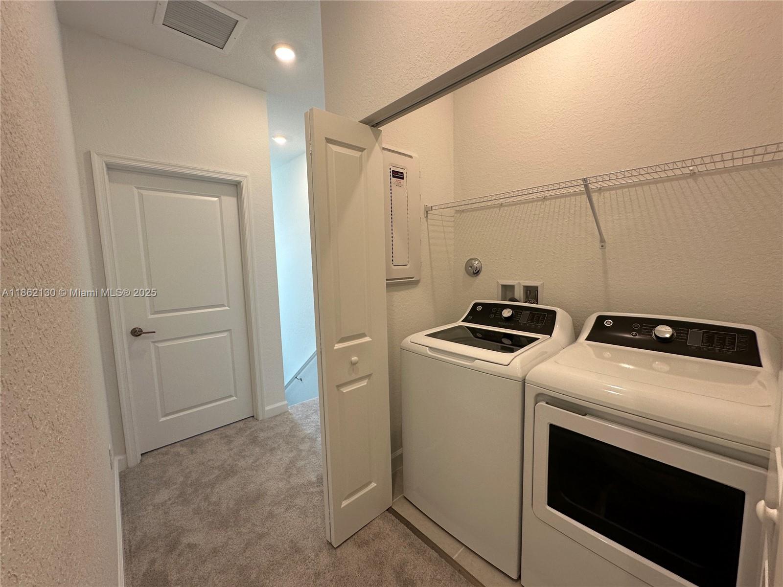 402 Southeast Crossoak Lane, Unit 402 Port St. Lucie, FL 34984 - Photo 86 of 87 a utility room with dryer and washer