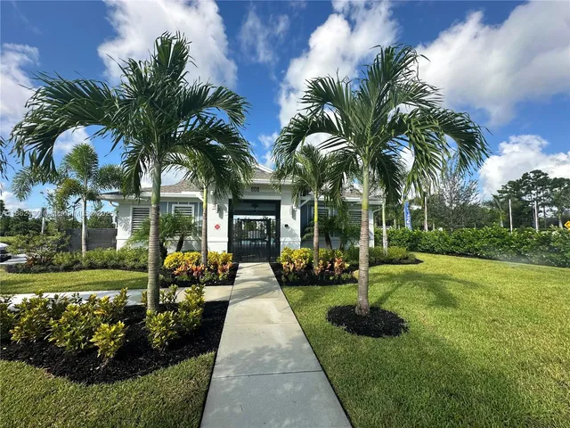 a view of a house with backyard and sitting area